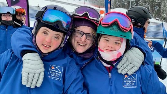 ASMS athletes and instructors celebrating together on the mountain